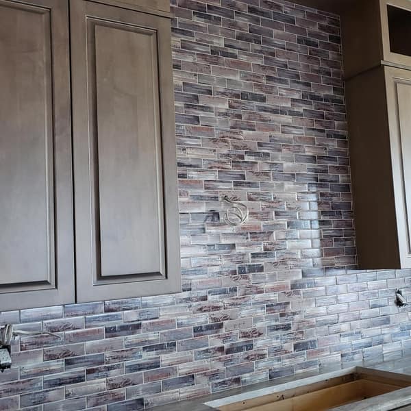 Multicolor brick-look glass tile backsplash in a kitchen