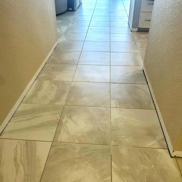 Large-format tile floor in a hallway