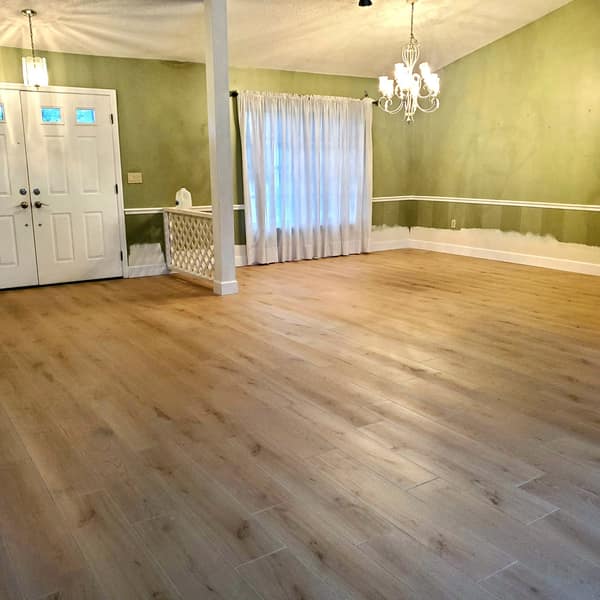 Wood-look floor in a dining area beneath a chandelier