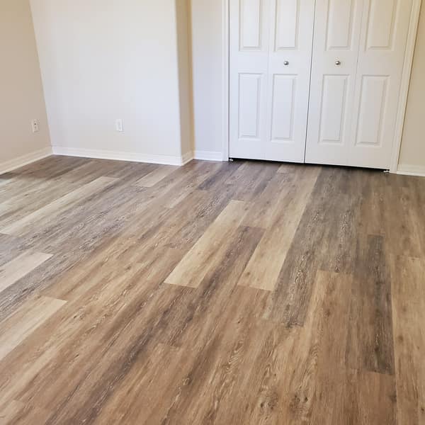 Luxury vinyl plank floor in a bedroom by the closet