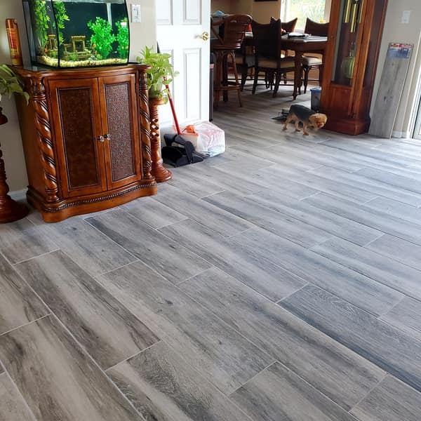 Gray wood-look plank tile floor in a dining room