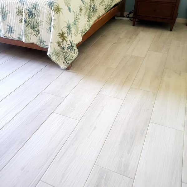 White wood-look plank tile floor in a bedroom