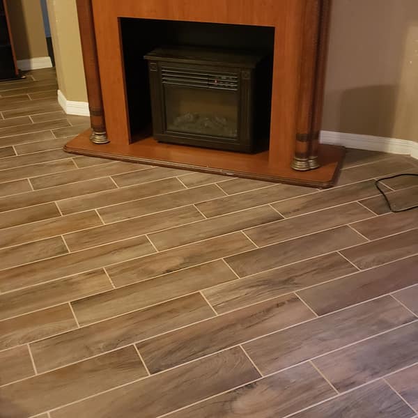 Wood-look plank tile floor in a living room with a fireplace