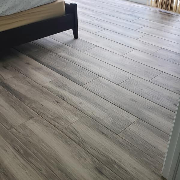 Gray wood-look plank tile floor in a bedroom